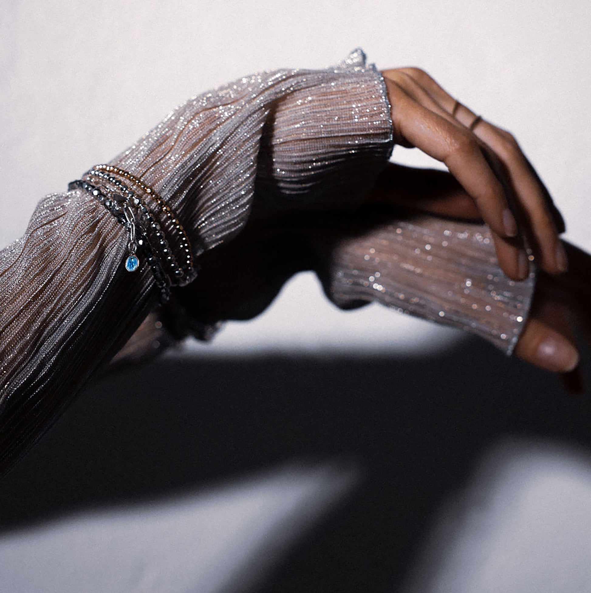 Catholic medal bracelet in sterling silver and blue enamel charm of Mother Mary, shown on an arm