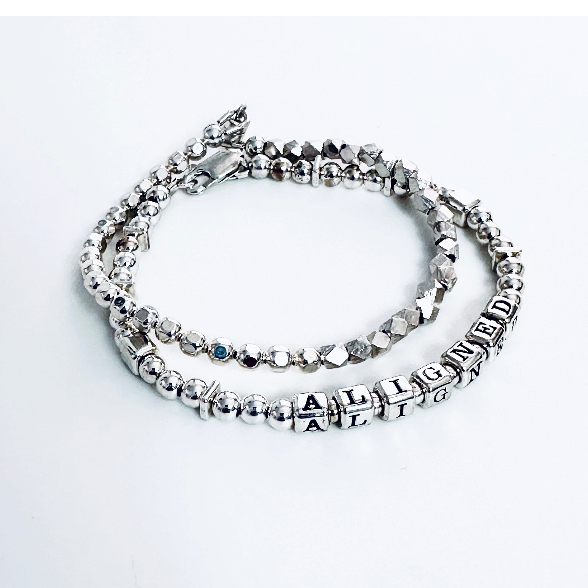 Sterling Silver Engraved Message Bracelet spelling out Aligned shown with additional sterling silver stacking  bracelet