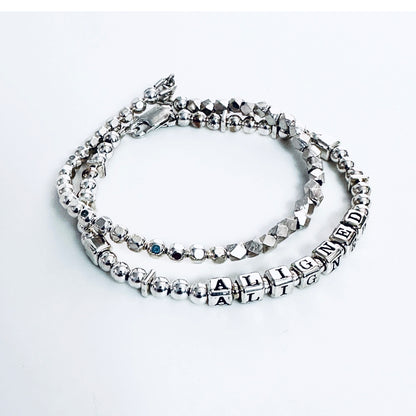 Sterling Silver Engraved Message Bracelet spelling out Aligned shown with additional sterling silver stacking  bracelet