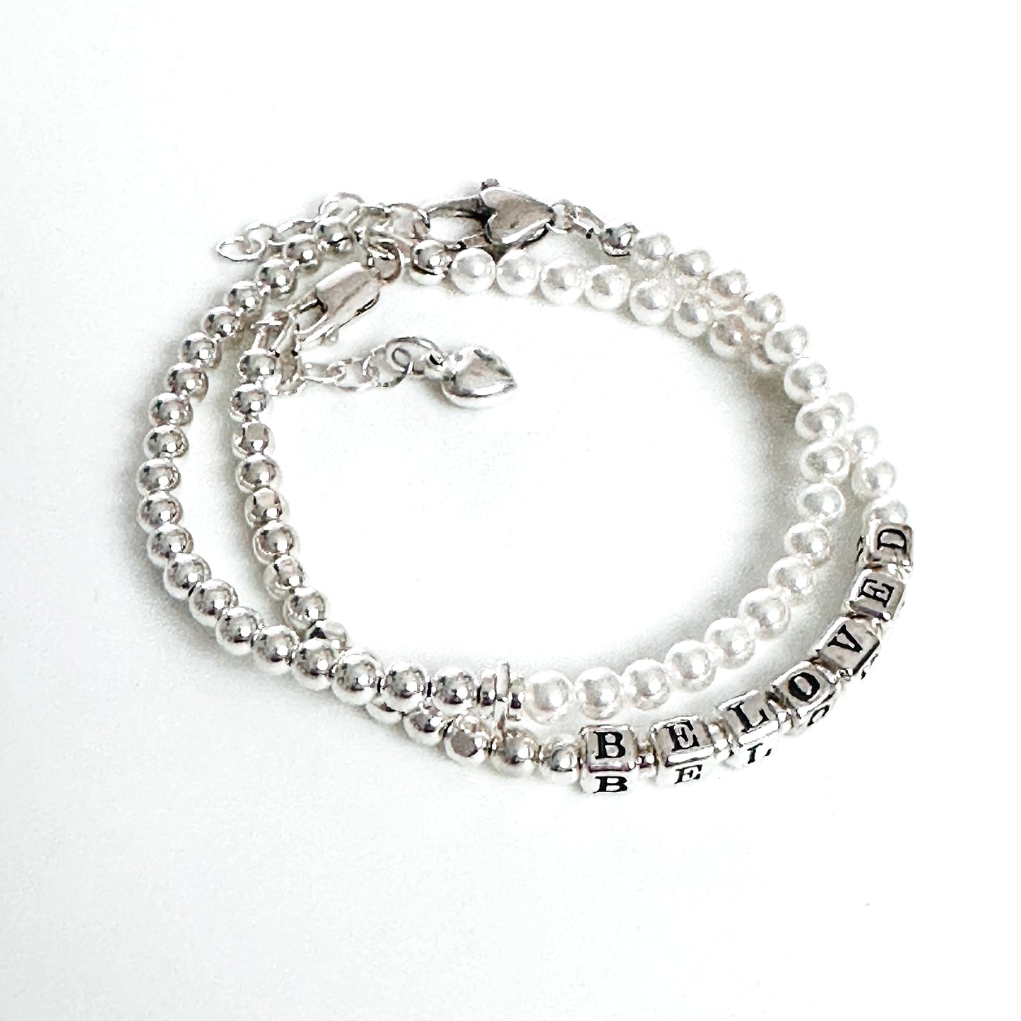 Beaded bracelet with sterling silver and pearls spelling out BELOVED, with heart charm and additional silver and pearl stacking bracelet