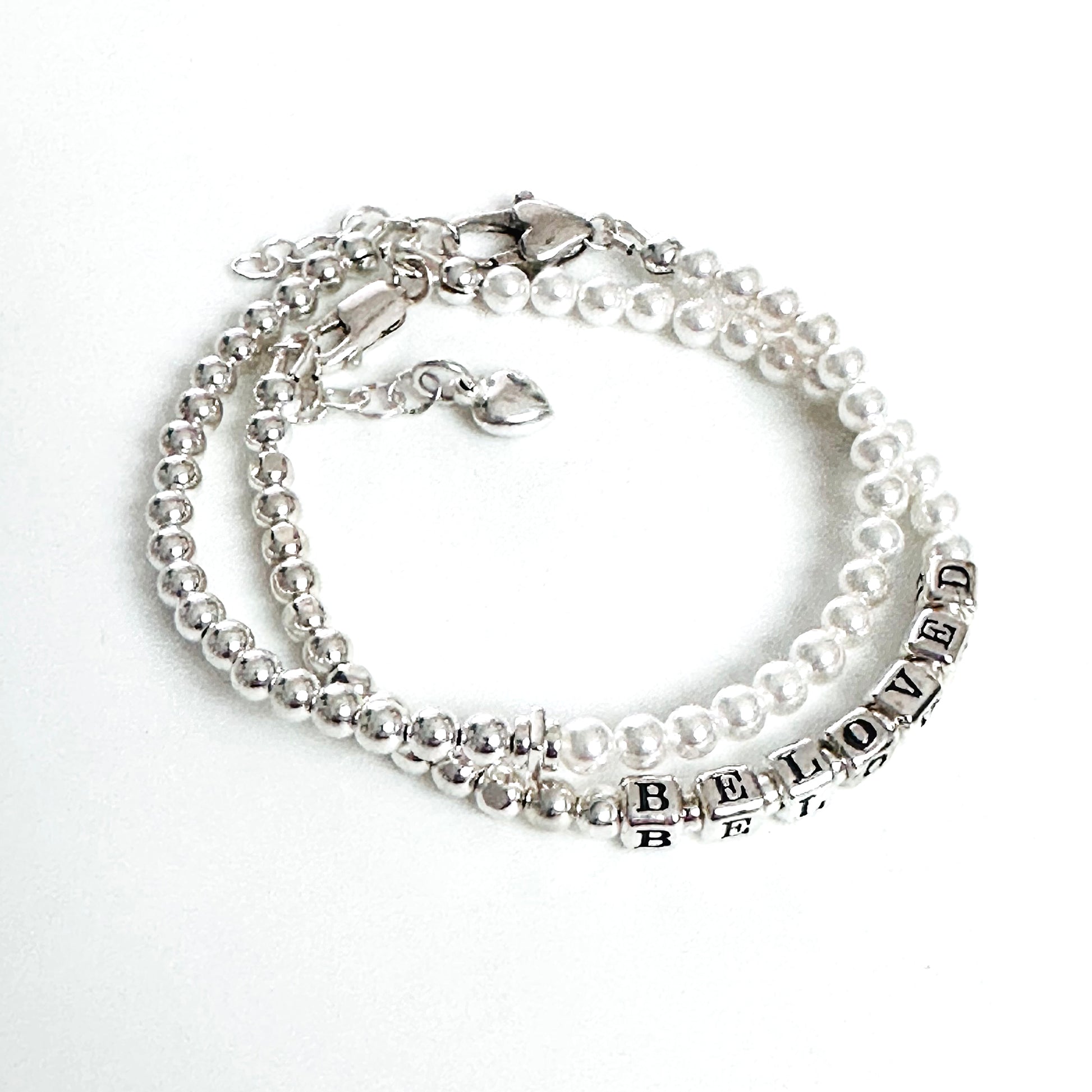 Beaded bracelet with sterling silver and pearls spelling out BELOVED, with heart charm and additional silver and pearl stacking bracelet