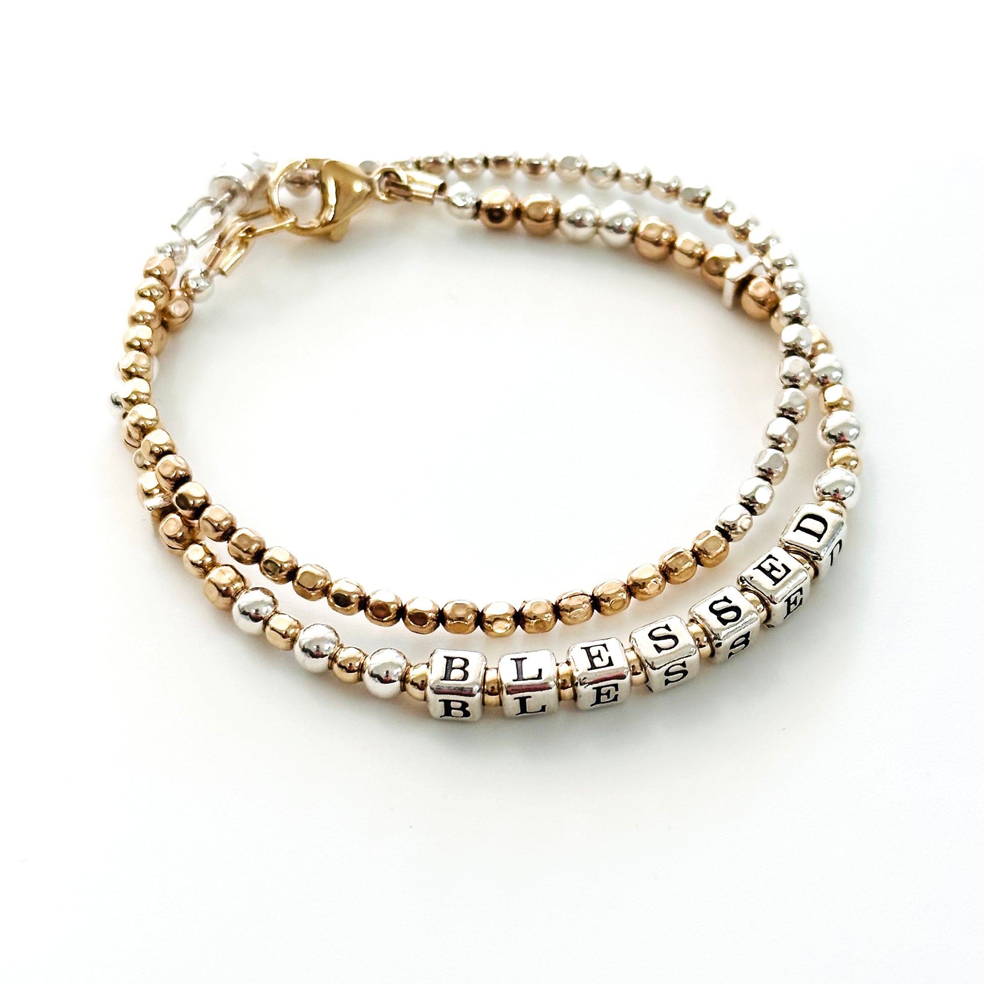 Sterling Silver and 14k Gold Hand Beaded bracelet spells out the affirmation BLESSED, shown with matching mixed metal beaded bracelet