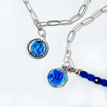 Detail of two modern Catholic jewelry bracelets, with sterling silver and blue medals of Lourdes Mother Mary