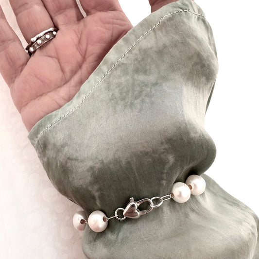 Sterling silver bracelet with floating pearls and sterling silver heart clasp