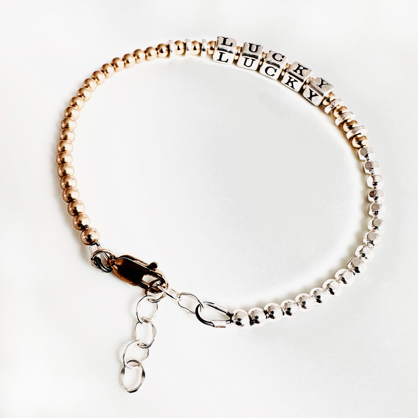 Sterling Silver and 14k Gold Hand Beaded bracelet spells out the affirmation LUCKY