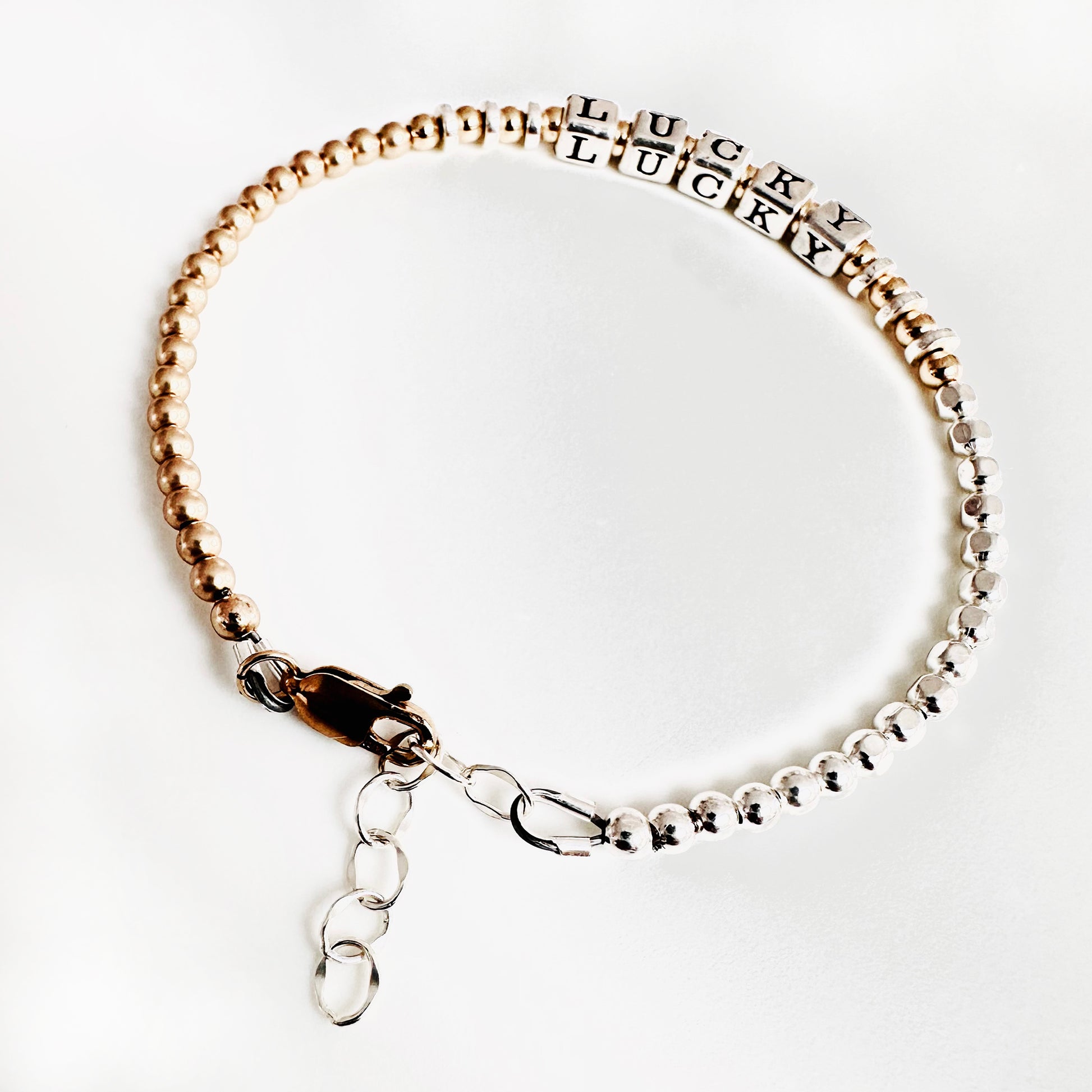 Sterling Silver and 14k Gold Hand Beaded bracelet spells out the affirmation LUCKY