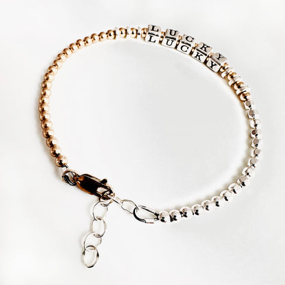 Sterling Silver and 14k Gold Hand Beaded bracelet spells out the affirmation LUCKY