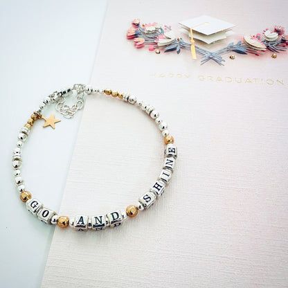 College Graduation Gift Bracelet in sterling silver and 14k gold, spelling out GO AND SHINE, and gold star charm