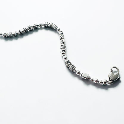 Love Bracelet in all sterling silver spells out Because You Loved Me, shown with heart clasp